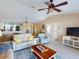 Open living room with ceiling fan, modern furniture, and view of the kitchen at 26333 Nadir Rd # 111, Punta Gorda, FL 33983