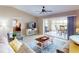 Bright living room with ceiling fan, sliding glass doors to screened porch and comfortable furnishings at 26333 Nadir Rd # 111, Punta Gorda, FL 33983