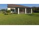 Screened-in porch offers a relaxing retreat in the backyard, surrounded by lush greenery and a well-maintained lawn at 2739 Sherman Oak Dr, North Port, FL 34289