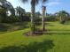 Sprawling backyard with manicured lawn and tranquil pond views, perfect for outdoor enjoyment at 2739 Sherman Oak Dr, North Port, FL 34289