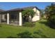 The backyard features a screened lanai and lush tropical landscaping, perfect for enjoying outdoor living at 2739 Sherman Oak Dr, North Port, FL 34289
