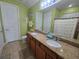 Bright bathroom featuring double vanity, granite countertops, and decorative beach themed accents at 2739 Sherman Oak Dr, North Port, FL 34289