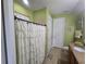 Bright bathroom featuring a shower, neutral tile, and granite countertop sink at 2739 Sherman Oak Dr, North Port, FL 34289