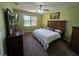Cozy bedroom with a ceiling fan, a large window, and nice furniture at 2739 Sherman Oak Dr, North Port, FL 34289