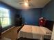 Cozy bedroom with a ceiling fan, window and a comfortable bed with dark furniture at 2739 Sherman Oak Dr, North Port, FL 34289