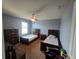 Bright bedroom with two beds, dark furniture, ceiling fan, and a window at 2739 Sherman Oak Dr, North Port, FL 34289