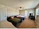 Bedroom features three twin beds with metal frames, ceiling fan and carpeted floors at 2739 Sherman Oak Dr, North Port, FL 34289