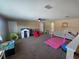 Large bonus room featuring neutral walls, carpeting, ceiling fan, and play and athletic equipment at 2739 Sherman Oak Dr, North Port, FL 34289