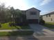 Charming two-story home with lush landscaping, well-maintained lawn, and a spacious driveway leading to a two-car garage at 2739 Sherman Oak Dr, North Port, FL 34289