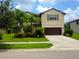 Inviting two-story home with a well-manicured lawn and a two-car garage, perfect for Gathering living at 2739 Sherman Oak Dr, North Port, FL 34289