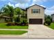 Inviting two-story home with a well-manicured lawn and a two-car garage, perfect for Gathering living at 2739 Sherman Oak Dr, North Port, FL 34289