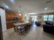 Spacious kitchen with granite countertops, island with bar seating and stainless steel appliances at 2739 Sherman Oak Dr, North Port, FL 34289