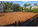 Community playground set on mulch with swings, landscaping and perimeter fencing at 2739 Sherman Oak Dr, North Port, FL 34289