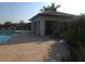 Community pool with tables, chairs and a covered area perfect for entertaining at 2739 Sherman Oak Dr, North Port, FL 34289