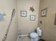Charming powder room featuring coastal decor and a convenient toilet with tile flooring at 2739 Sherman Oak Dr, North Port, FL 34289