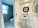 Small bathroom with pedestal sink, tiled floor, toilet and window at 3122 Scranton St, Port Charlotte, FL 33952