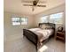 Bright bedroom with a ceiling fan, tile flooring and two windows providing plenty of natural light at 3122 Scranton St, Port Charlotte, FL 33952