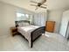 Comfortable bedroom featuring tile floors, a ceiling fan, and a window view at 3122 Scranton St, Port Charlotte, FL 33952