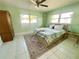 Bedroom with a ceiling fan, a large window with natural light, and tile floors at 3122 Scranton St, Port Charlotte, FL 33952