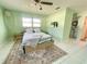 Comfortable bedroom featuring tile floors, a ceiling fan, and an en-suite bathroom at 3122 Scranton St, Port Charlotte, FL 33952