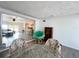 Dining room with papasan chair, vintage chairs and a view into the living room and kitchen at 3122 Scranton St, Port Charlotte, FL 33952