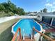 Above-ground pool with wooden deck, perfect for summer relaxation and outdoor entertaining at 3122 Scranton St, Port Charlotte, FL 33952