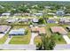 An aerial view showcases a quiet neighborhood with tree-lined streets and well-maintained homes at 315 Holly Rd, Venice, FL 34293