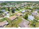 An aerial view captures the property nestled in a serene community with lush greenery at 315 Holly Rd, Venice, FL 34293