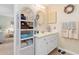Bathroom with an oval mirror, seashell decorations, and a wicker storage shelf at 315 Holly Rd, Venice, FL 34293