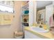 Bathroom featuring yellow countertops and shelving stocked with towels at 315 Holly Rd, Venice, FL 34293
