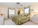 Comfortable bedroom with a ceiling fan, carpeted floor, and bright windows at 315 Holly Rd, Venice, FL 34293
