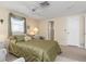 Inviting bedroom with a ceiling fan, carpeted floor, and natural light at 315 Holly Rd, Venice, FL 34293