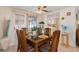 Cozy dining room featuring a ceiling fan and sliding glass doors for great natural light at 315 Holly Rd, Venice, FL 34293