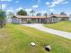 Landscaped single-story home with a long driveway and well-manicured lawn at 315 Holly Rd, Venice, FL 34293