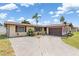 Inviting single-story home with a spacious driveway, attached garage, and well-kept landscaping at 315 Holly Rd, Venice, FL 34293