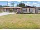 Charming single-story home featuring a well-maintained lawn, palm trees, and an American flag at 315 Holly Rd, Venice, FL 34293