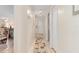 Hallway featuring neutral tones, tile flooring, and decorative rug at 315 Holly Rd, Venice, FL 34293