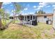 A patio with seating offers a relaxing outdoor space for entertaining and enjoying the backyard at 315 Holly Rd, Venice, FL 34293