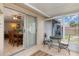Enclosed patio with tiled floors, dining set, and sliding glass doors to the dining room at 315 Holly Rd, Venice, FL 34293