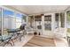 Enclosed patio with tiled floor and multiple seating areas at 315 Holly Rd, Venice, FL 34293