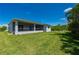 Picture of a spacious, green backyard with a screened-in lanai perfect for enjoying the outdoors at 3302 Palm Dr, Punta Gorda, FL 33950