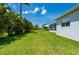 Lush backyard and screened-in lanai offering a perfect blend of outdoor enjoyment and comfortable living space at 3302 Palm Dr, Punta Gorda, FL 33950