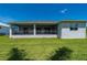 Spacious backyard with a large screened-in lanai, providing ample space for outdoor activities and relaxation at 3302 Palm Dr, Punta Gorda, FL 33950
