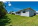 Lush backyard with well-manicured lawn and screened-in lanai, ideal for outdoor entertainment and relaxation at 3302 Palm Dr, Punta Gorda, FL 33950