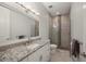 Modern bathroom with granite countertop, and tiled shower featuring stone details at 3302 Palm Dr, Punta Gorda, FL 33950