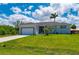 Well-maintained single-story home with green lawn, garage, and attractive landscaping details at 3302 Palm Dr, Punta Gorda, FL 33950
