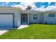 Close up of attractive single-story home featuring green lawn and front entry at 3302 Palm Dr, Punta Gorda, FL 33950