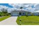 This home offers a well-manicured lawn, two-car garage, and inviting landscaping at 3302 Palm Dr, Punta Gorda, FL 33950