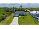 Charming home with a well-manicured front lawn and a clean, inviting exterior, enhanced by a modern driveway at 3302 Palm Dr, Punta Gorda, FL 33950