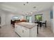 Open-concept kitchen features an island, stainless appliances, and a large sectional sofa at 3302 Palm Dr, Punta Gorda, FL 33950